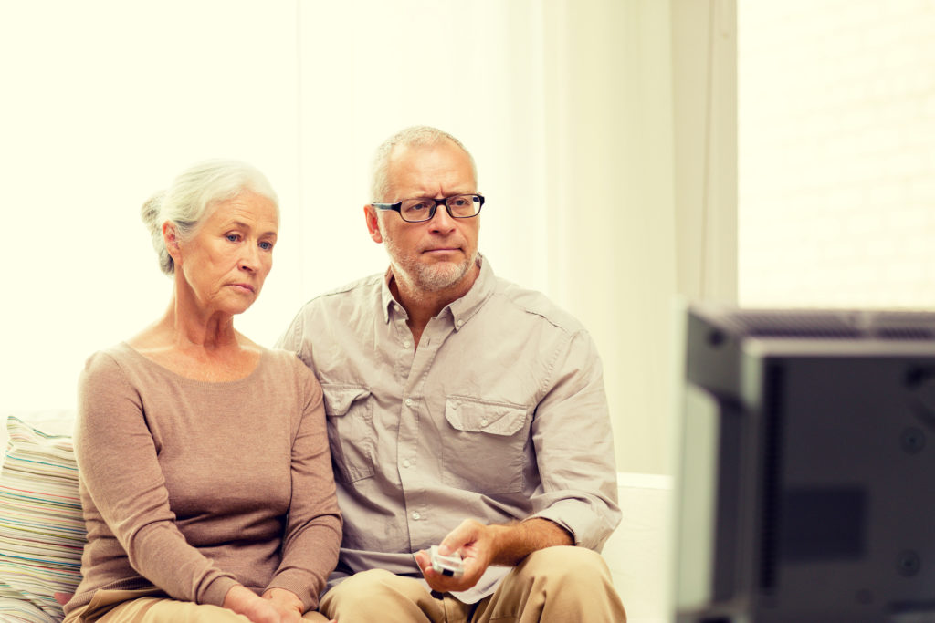 Couple watching TV commercial
