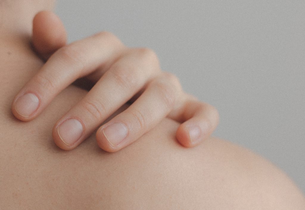Close up of hand on shoulder