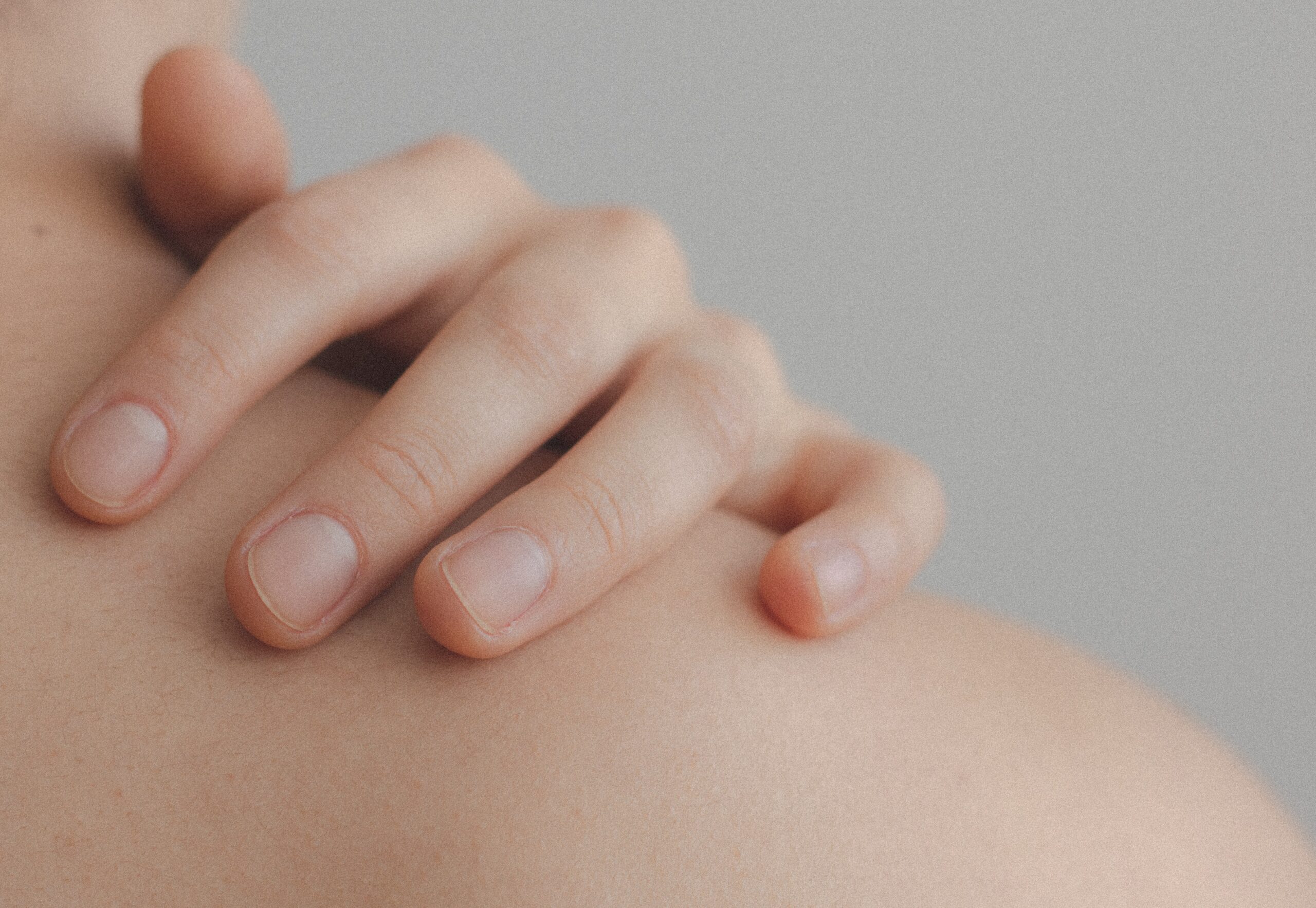 Close up of hand on shoulder