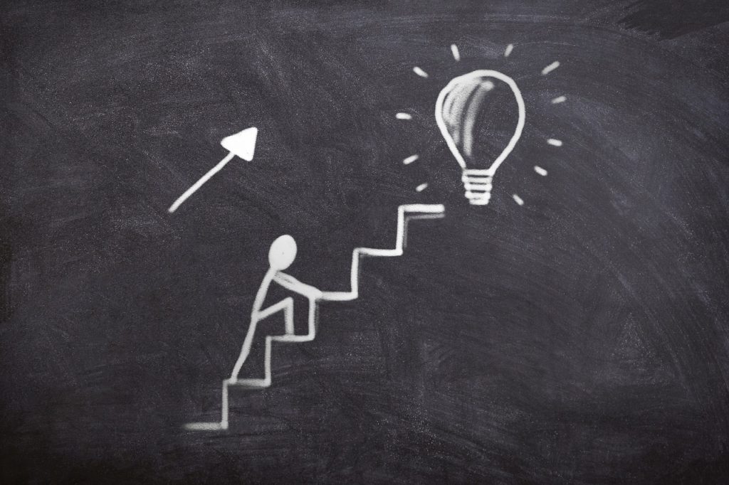 Chalkboard drawing of climbing the ladder of success concept