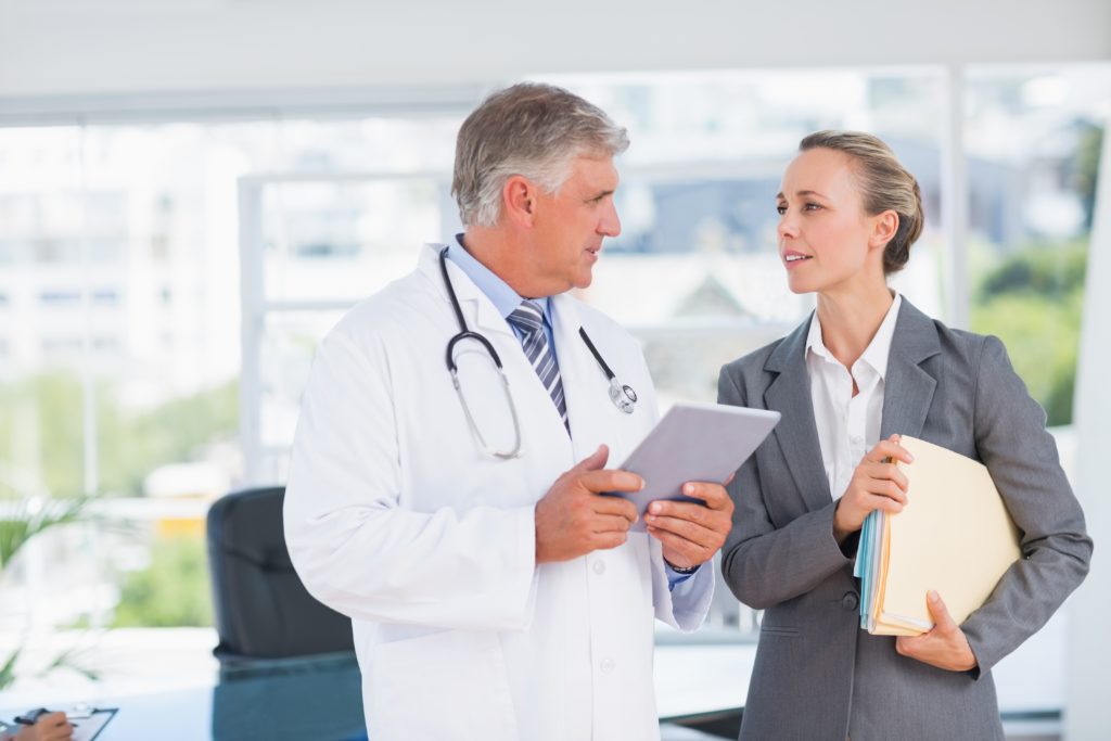 Doctor with colleague discussing clinical trial