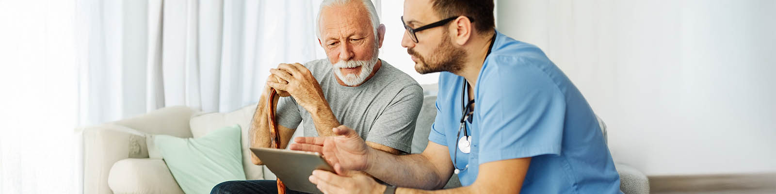 Nurse using tablet with a man Hero